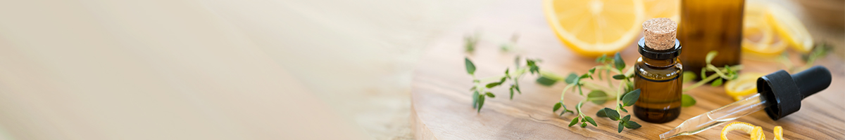 Image of herbs and an orange on a table.