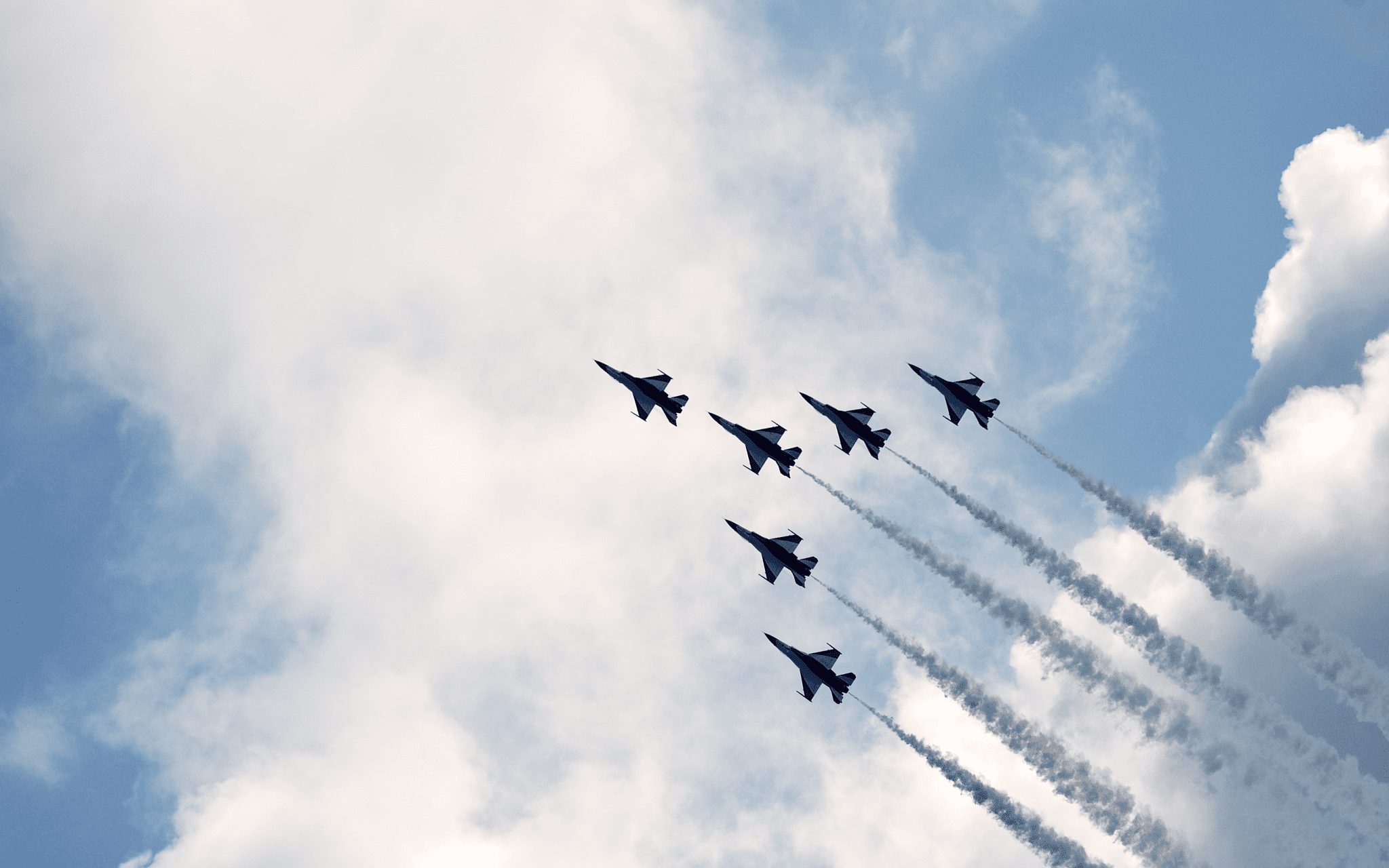 Air Force fighter jets flying through the sky.