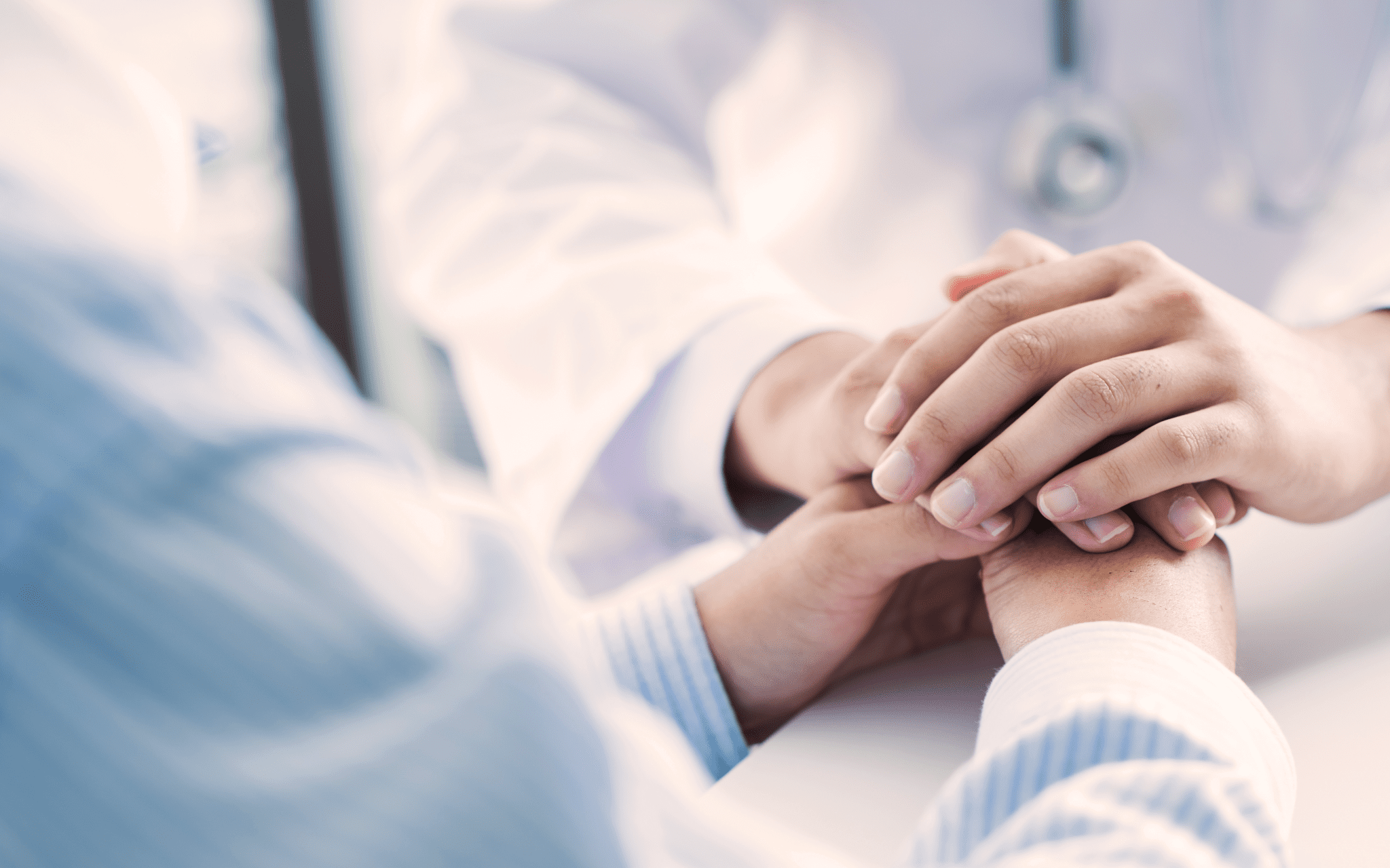 Closeup of doctor holding their patients hands and giving them a diagnosis..