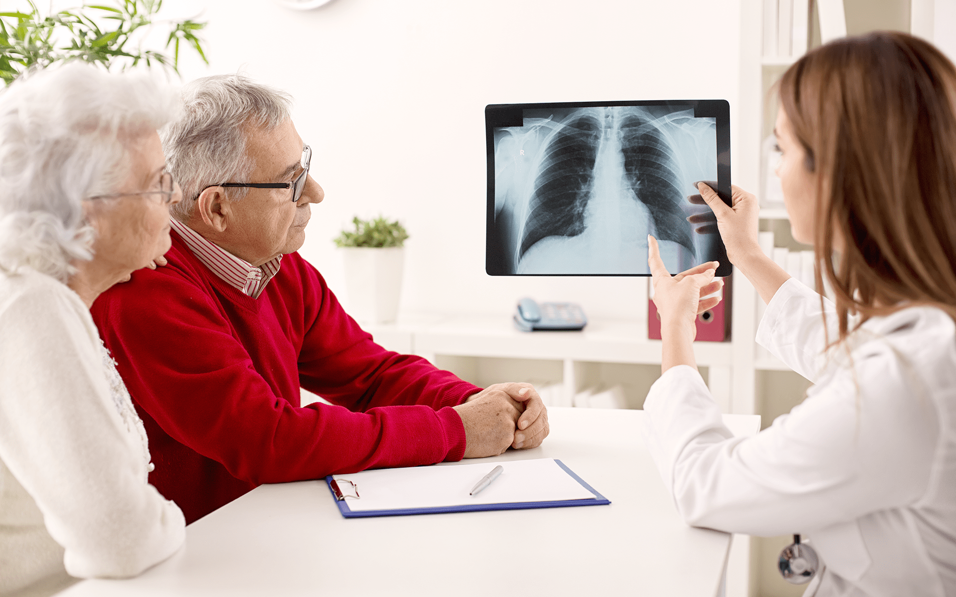 Mesothelioma doctor explaining stage one cancer to an elderly couple.