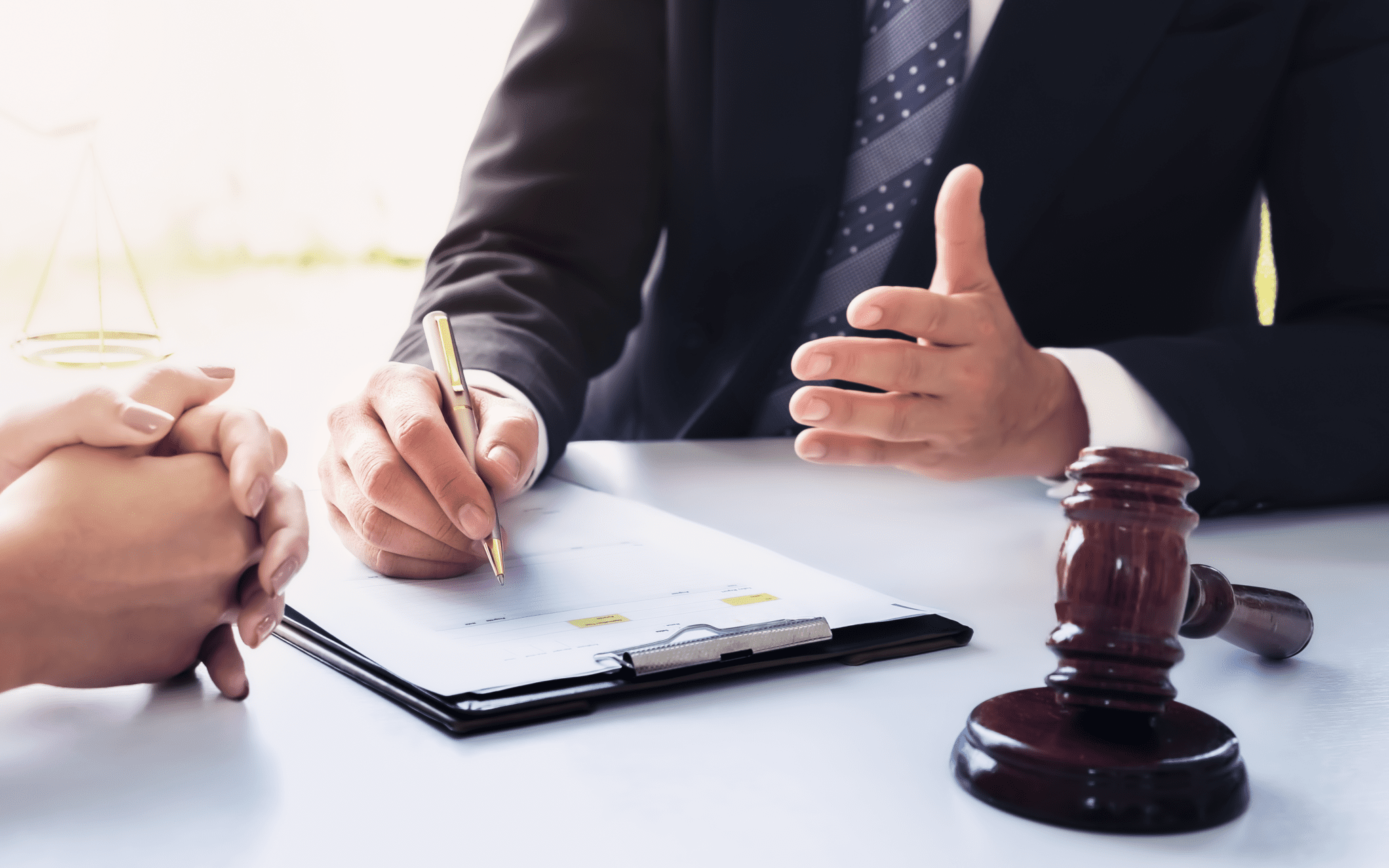 Closeup of a mesothelioma attorney hands while gesturing to someone about class action lawsuits.