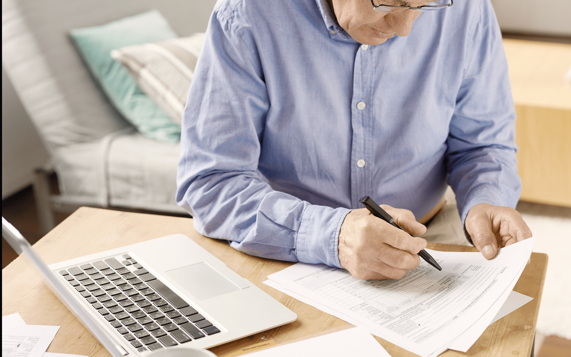 Man fills out documents in order to file for benefits