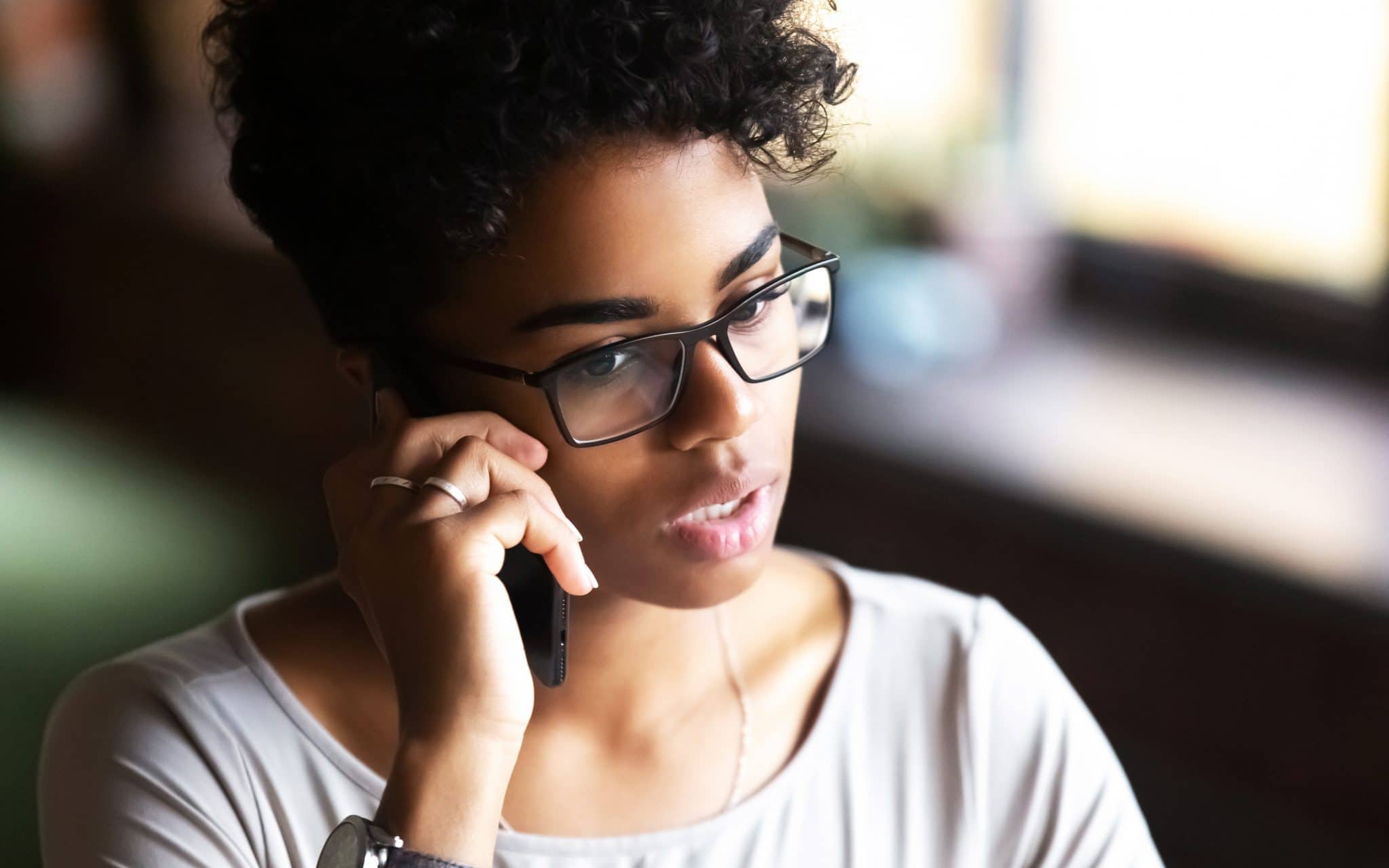 Woman asking a question on a cell phone.