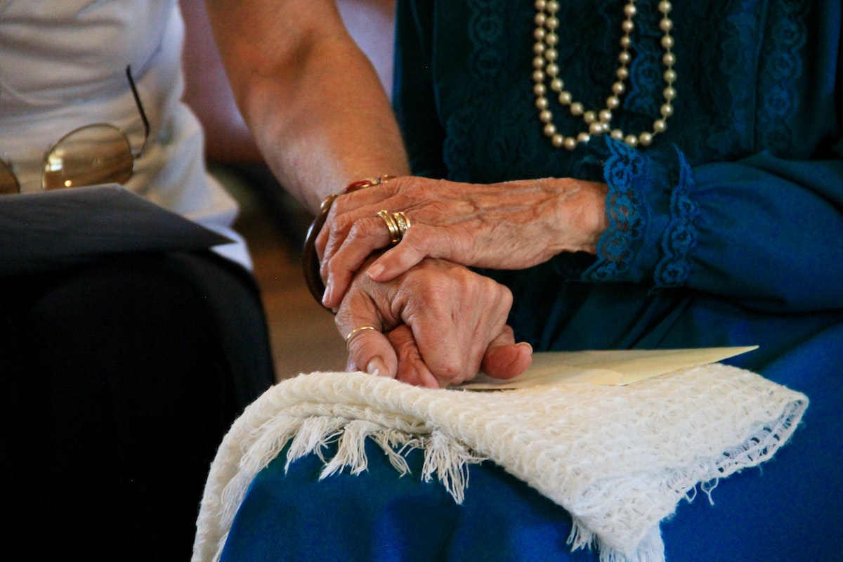 caregiver holding hands with veteran