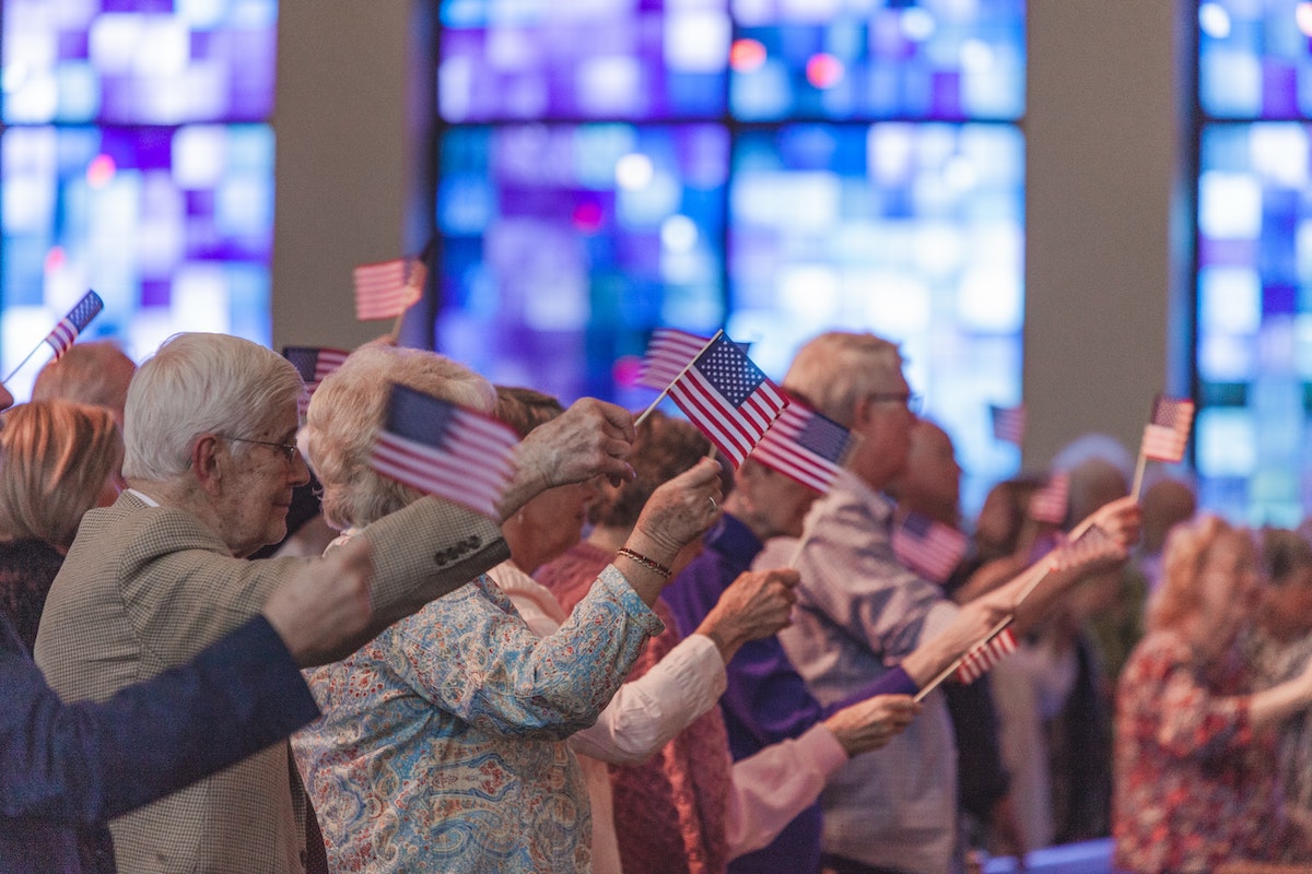 a group of seniors waves small flags