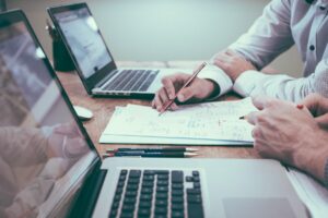 close up on the hands of a fiduciary money manager working with a client