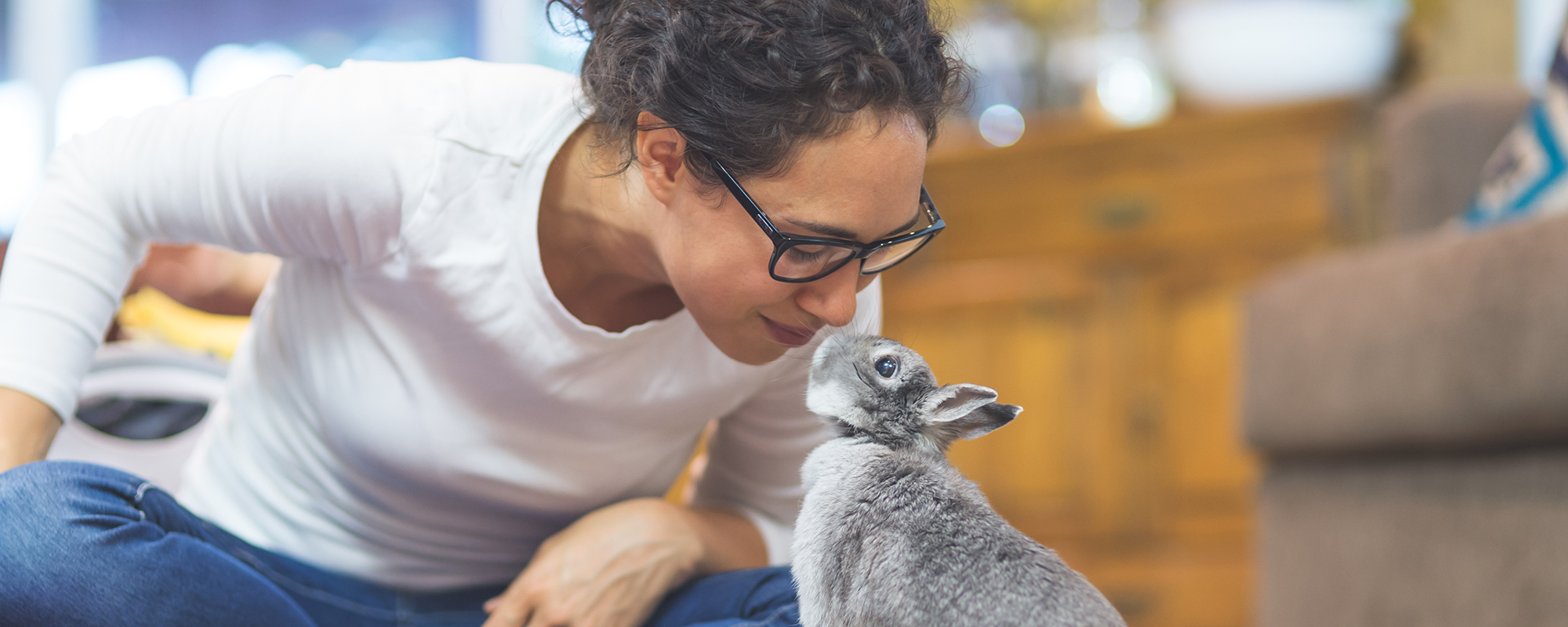 A woman admiring her pet bunny.