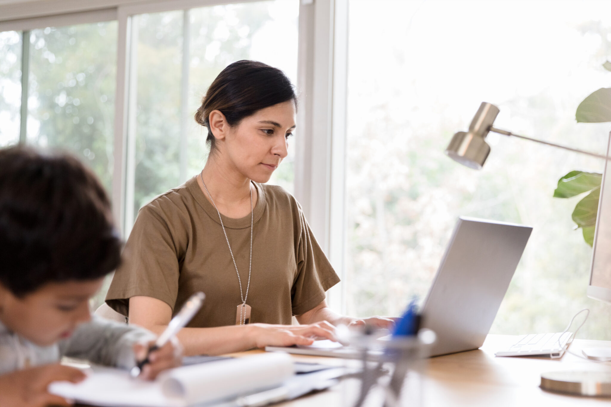 A women fills out a veteran scholarship and grant application