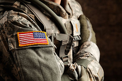 army veteran in uniform with the usa flag on their sleeve