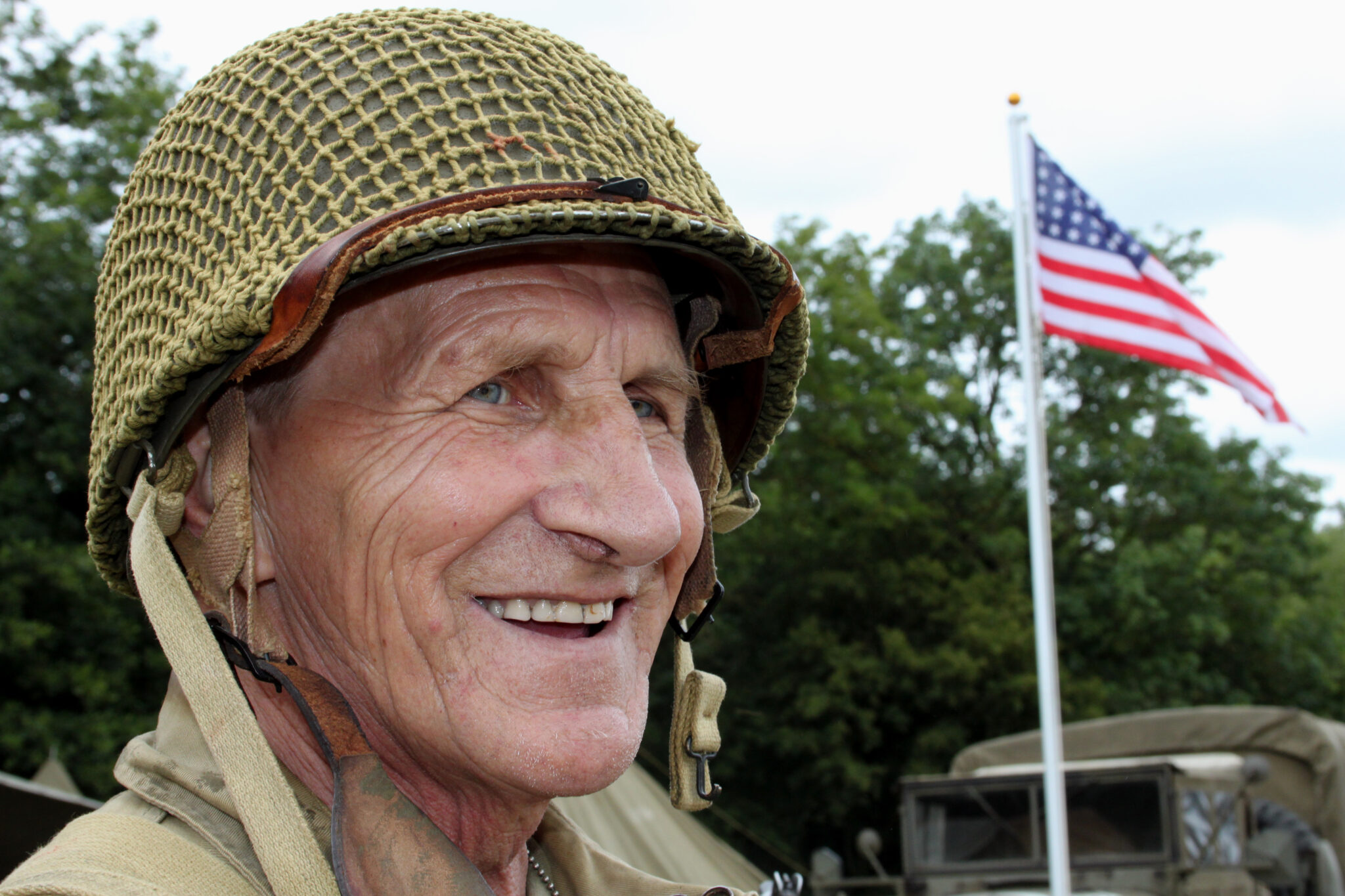 Atomic veteran standing in front of an American flag