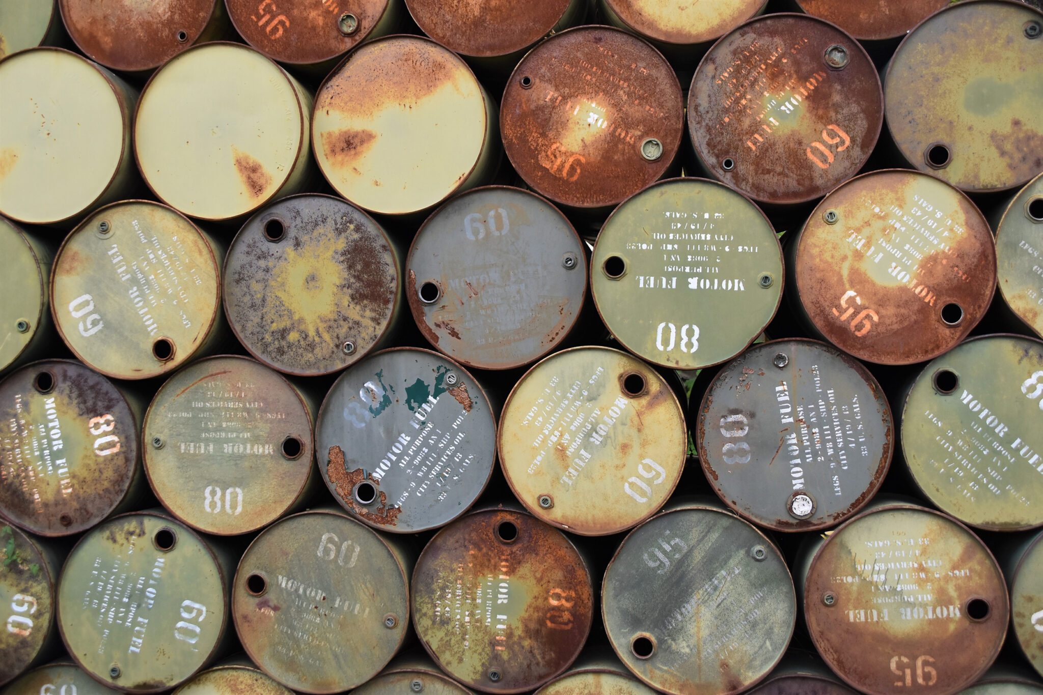 Rusty barrels are stacked at toxic superfund site that holds contaminants from metal and other pollutants.