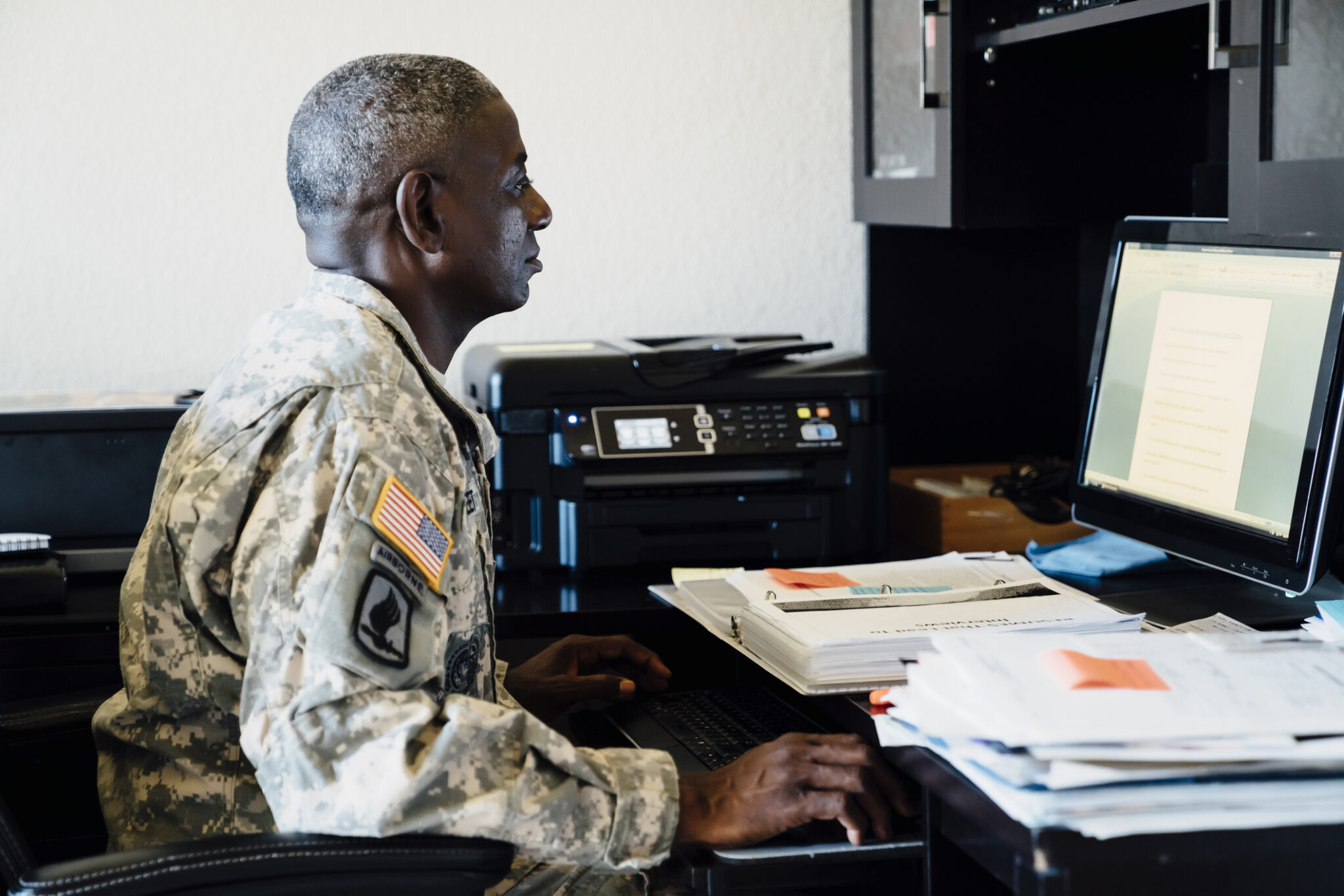 Veteran doing paperwork on computer get DD 214