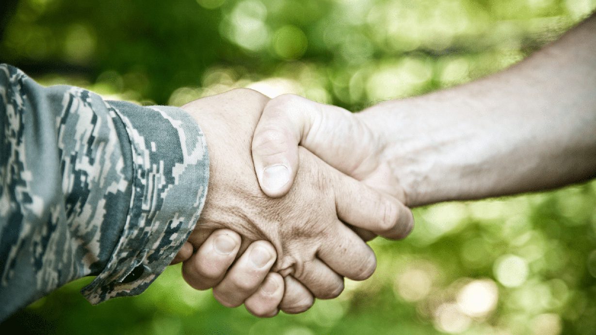 Military veteran shaking hands with citizen