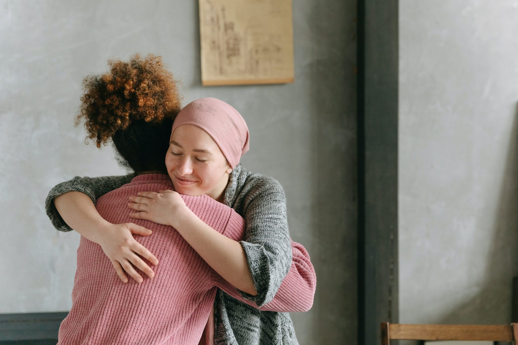 A women hugging another women veteran with breast cancer, one five most common cancers for veteran.